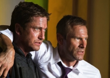 Agent Mike Banning (Gerard Butler) helps President Benjamin Asher (Aaron Eckhart) out of the White House after rescuing him from terrorists.