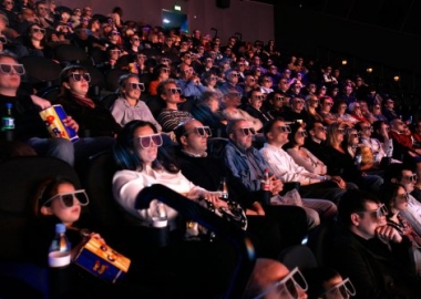 An audience at a movie wearing modern 3D cross polarization glasses.