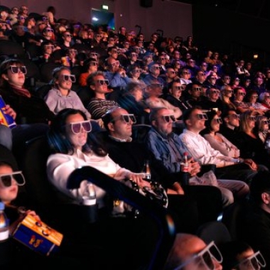 An audience at a movie wearing modern 3D cross polarization glasses.