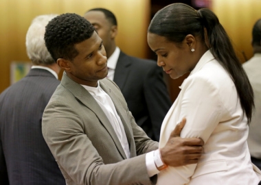 R&B singer Usher, left, embraces ex-wife Tameka Foster Raymond, after a judge dismissed an emergency request by Raymond seeking temporary custody of their two children, Friday in Atlanta. Raymond had requested the hearing earlier this week after their 5-year-old son got caught in a pool drain while in the care of the Grammy winner's aunt. (David Goldman/AP)