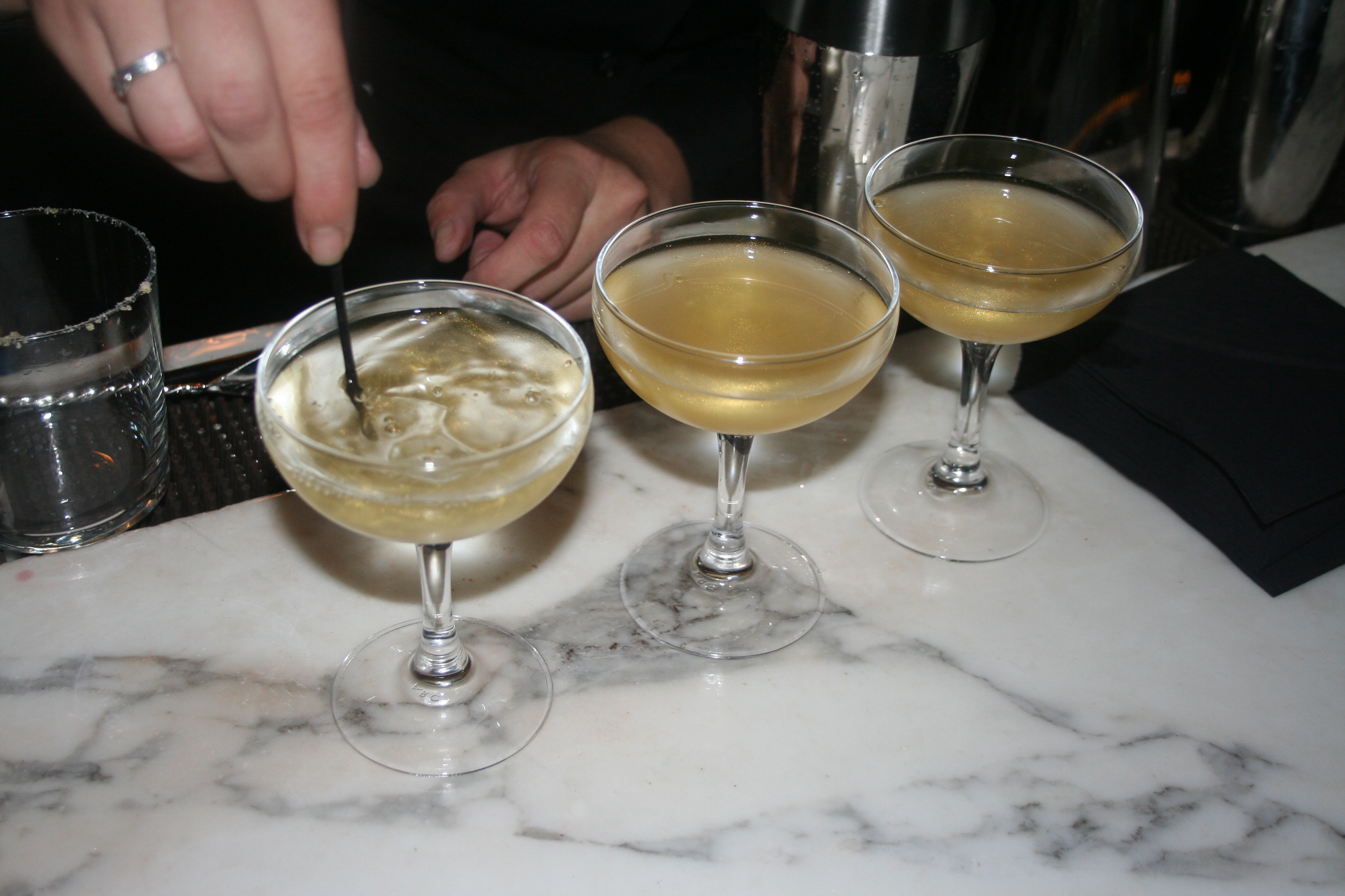 A bartender adds gold dust to the new Goldfinger martini available at both bars and the martini cart. (Mark Heckathorn/DC on Heels)