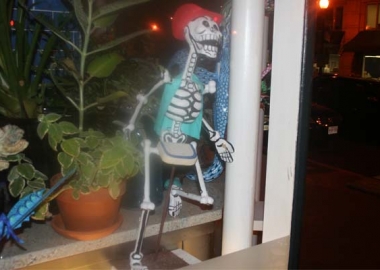 A catrinas, satirical skeletons made famous by Jose Guadalupe Posada, in the window of Oyamel. The skeletons have become an icon of the Mexican Day of the Dead. (Mark Heckathorn/DC on Heels)