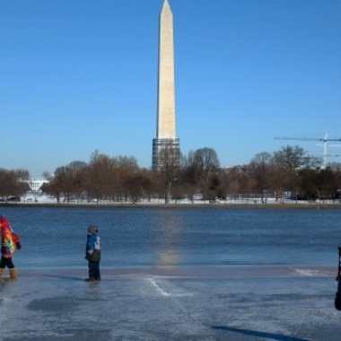 Children slide along an ice-covered walkway near the Washington Monument Saturday. But with the polar vortex coming Monday and Tuesday you should stay inside or dress warmly if you must go out. (Photo: Karen Bleier/AFP/Getty Images)