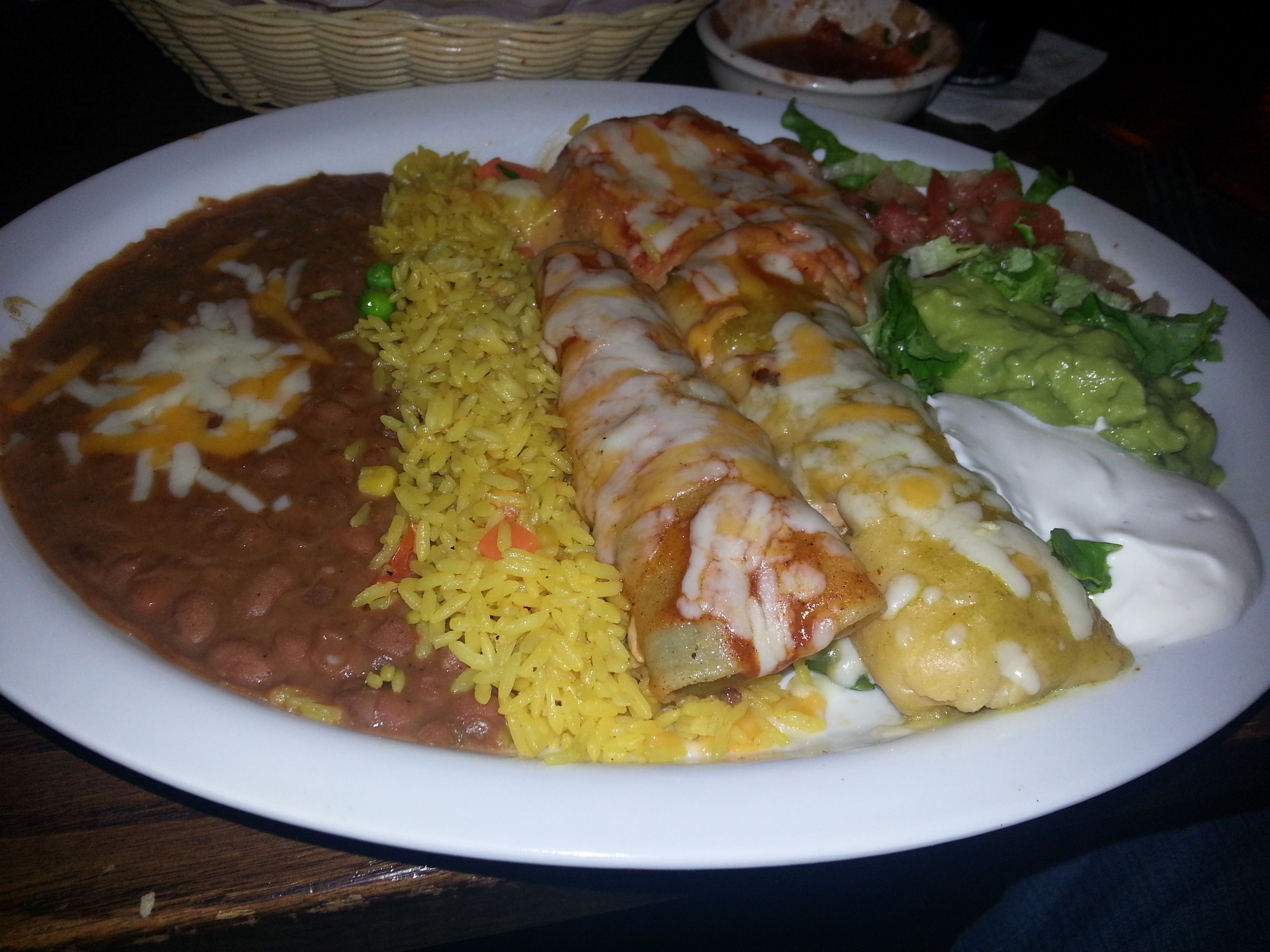 El Tio's Mexican platter with (l to r) refried beans, Mexican rice, beef enchilada, chile rellano (rear), chicken tamale (front), pica de gallo, lettuce, guacamole and sour cream. (Photo: Mark Heckathorn/DC on Heels)