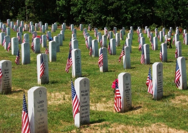 Graved at Arlington National Cemetery are decorated with flags for Memorial Day. (Photo: Indian Barrister)