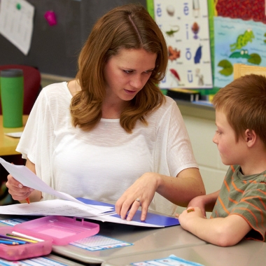 A teacher works with an elementary student. (Photo: Penn State)