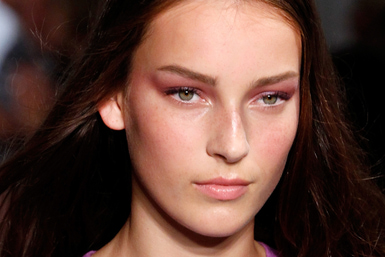  Tom Pecheux created a beautiful, translucent, almost bruise-like violet eye paired with a soft pink lip for Derek Lam. (Photo: JP Yim/Getty Images)
