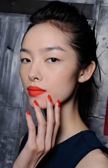 Matching red lips and nail are in. (Photo: Imaxtree)