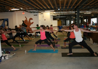 Bendy Brunch participants practice yoga among art at the old Wonder Bread Factory. (Photo: Mark Heckathorn/DC on Heels)