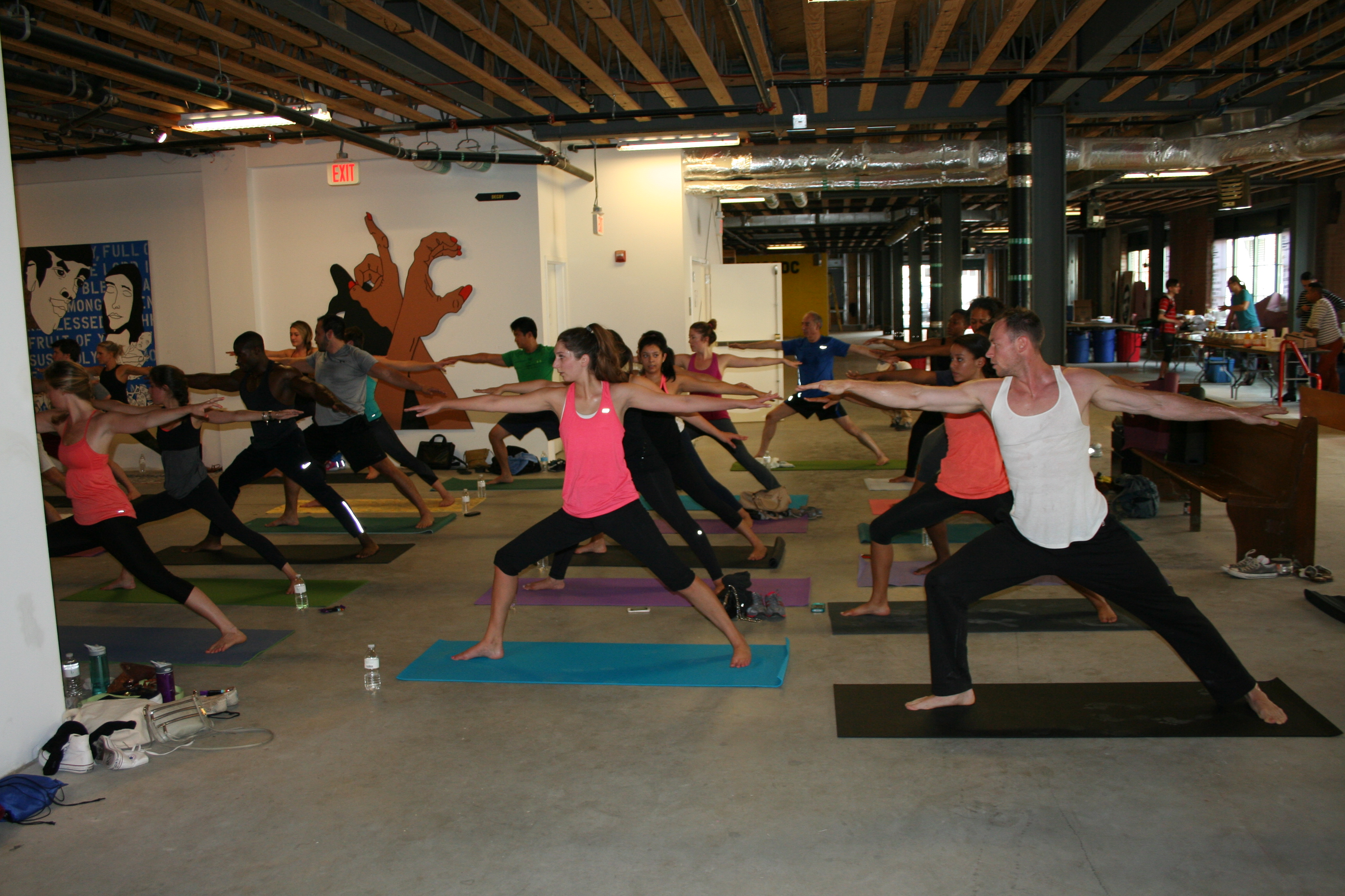 Bendy Brunch participants practice yoga among art at the old Wonder Bread Factory. (Photo: Mark Heckathorn/DC on Heels)
