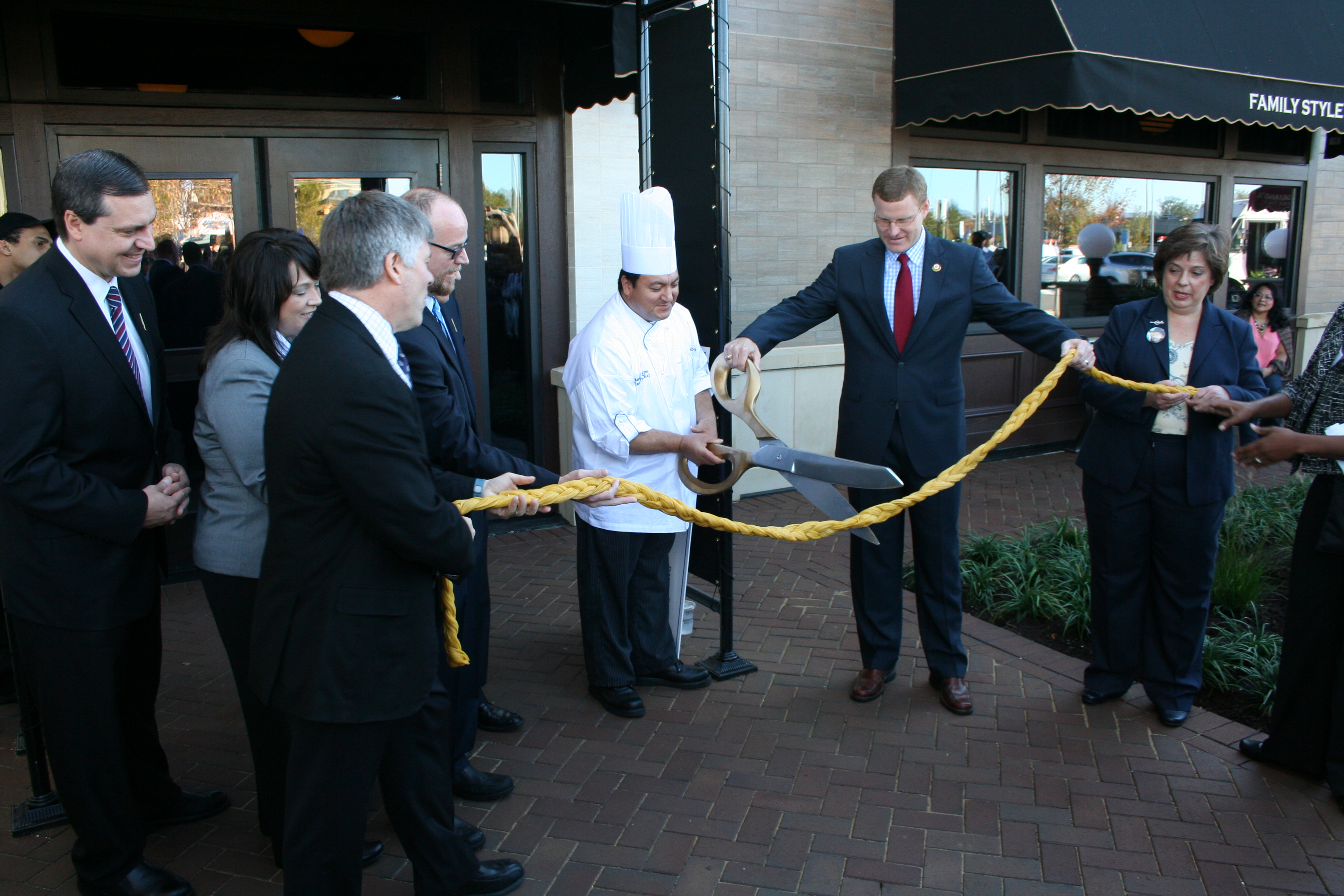 Executive chef Manny Duron and Fairfax County Supervisor Jeffrey McKay cut a 10-foot long fettuccini ribbon to open the new restaurant. (Photo: Mark Heckathorn/DC on Heels)