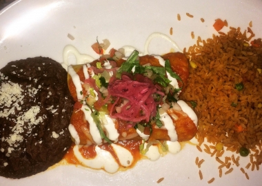 Beef brisket barbacoa enchiladas with refried beans and Mexican rice. (Photo: Diana Veseth-Nelson/DC on Heels)