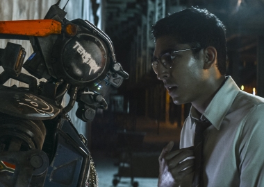 CHAPPiE (Sharlto Copley, left) and his creator Deon (Dev Petal) in CHAPPiE. (Photo: Sony Pictures)