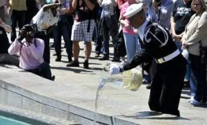  A sailor from the Navy Ceremonial Guard pours water collected from the seven seas and the Great Lakes into the fountains at the Navy Memorial to “charge” the fountains to life. (Photo: Mass Communication Specialist 2nd Class Zach Allan/U.S. Navy)