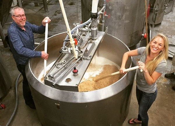 City Tap House's beverage director Dave Donaldson and director of sales and marketing Elizabeth Gartzke stir a batch of Persica Rising at 3 Stars Brewing. (Photo: City Tap House/Instagram)