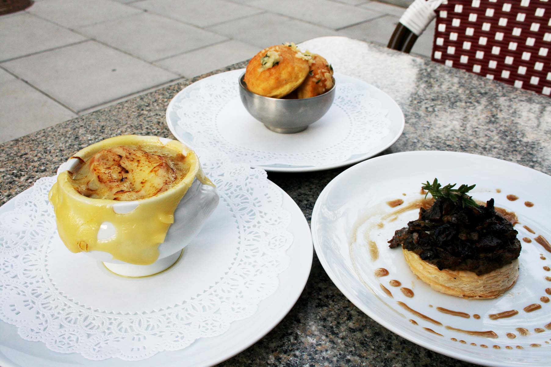 Appetizers include (clockwise from top) gougeres, mushroom tart and onion soup gratinee. (Photo: Mark Heckathorn/DC on Heels)