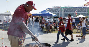 Warren Sumlin barbecues in the parking lot of FedEx Field before a Washington Redskins football game. (Evan Vucci/AP)