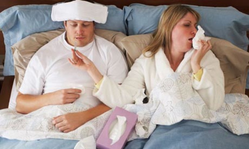 At least if you're sick together, you won't feel lonely. (Photo: Radius Images/Alamy)