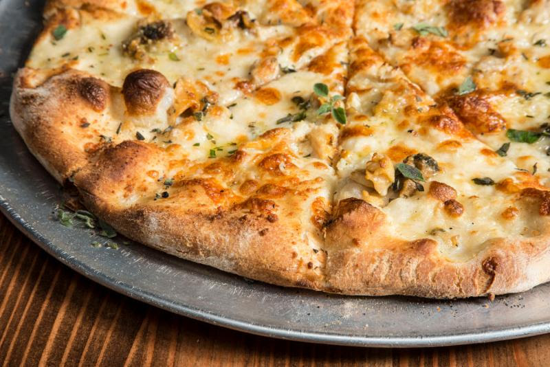 Pete's New Haven pizza includes clams, , garlic, oregano, extra virgin olive oil and pecorino romano. Pete's will be offer $2 every day in October for National Pizza Month. (Photo: Pete's New Haven Style Apizza)
