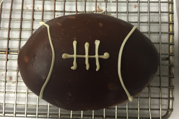 Astro Doughnuts & Fried Chicken is selling six football-shaped doughnuts in D.C. for $15 or with 24 chicken wings for $45 in Falls Church. (Photo; Astro Doughnuts & Fried Chicken)