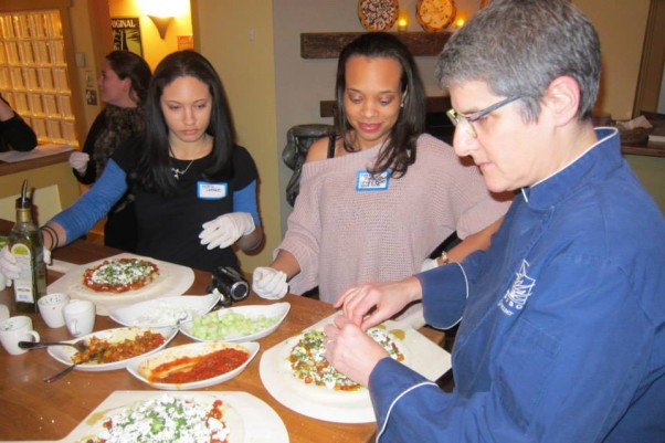 Chef Ruth Gresser (right) helps students make their own pizza. (Photo: Pizzeria Paridiso/Facebook)