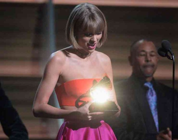 Taylor Swift accepts the Album of the Year Grammy. (Photo: Kevork Djansezian/WireImage)