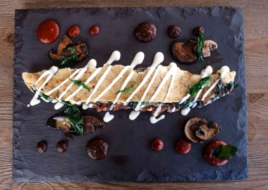 El machete is a N,Y. grilled strip with corn tortilla, Oaxaca cheese, epazote, mushroom, truffle oil, pasilla salsa and guajillo salsa. (Photo: Richard Sandoval Restaurants)