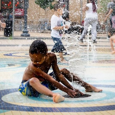 Kids cool down during the recent heat wave in the fountain at the Columbia Heights Civic Plaza. (Photo: vpickering/Flickr)