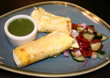 Bindaas' dishes include a chicken tikka masala kathi roll with cucumber, pepper and onion salad. (Photo: Mark Heckathorn/DC on Heels)