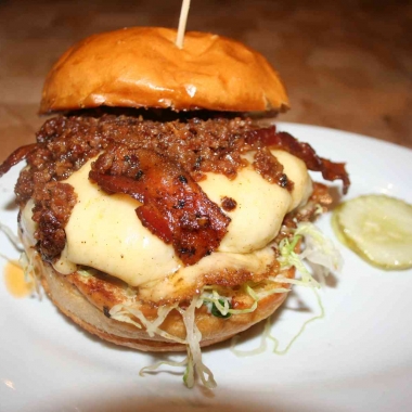 The Big Pig with an andouille and beef blended patty is topped with Applewood smoked bacon, lettuce, bacon onion jam, smoked mozzarella and garlic mayo. (Photo: Mark Heckathorn/DC on Heels)