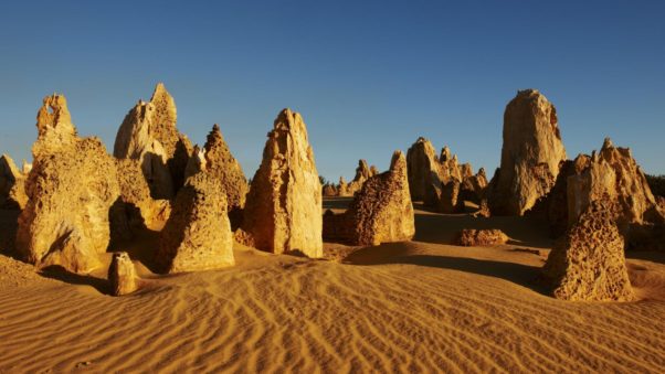 the Pinnacles are a collection of large, weirdly shaped limestone rock formations. Some believe they represent locals who died in the desert's quicksand. (Photo: Tourism Austrailia)
