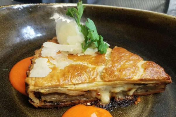 Vinoteca's new menu includes a layered Italian-style potato portobello torta served like a slice of pie with red pepper parmesan fonduta and truffle oil. (Photo: Vinoteca)