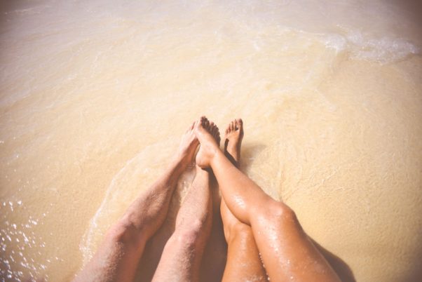 Couple lying on a beach. (Photo: Stocpic/Pexels)