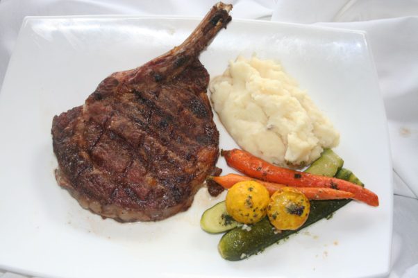 The new cowboy steak is served with mashed potatoes, vegetables and house-made steak sauce. (Photo: Mark Heckathorn/DC on Heels)