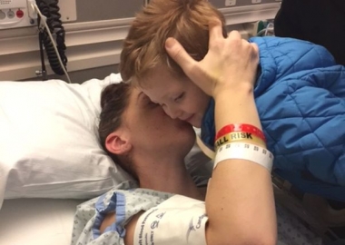 Lucy Alana Gnazzo kisses her son, Vincent, as he leans over her hospital bed. (Photo: Penn State)