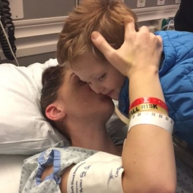 Lucy Alana Gnazzo kisses her son, Vincent, as he leans over her hospital bed. (Photo: Penn State)