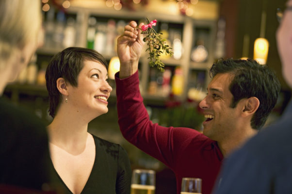 Even if there is mistletoe, it is best to keep things professional and not kiss under it at your office holiday party. (Photo: Getty Images)