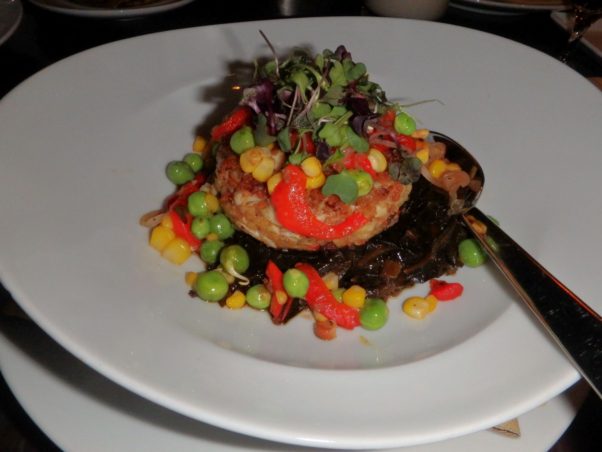 Jardenea's Maryland crab cake is served over Appalachian corn, roasted red peppers, smoked bacon and the best apple cider braised collard greens you will ever taste. (Photo: Nick Bullock/DC on Heels)