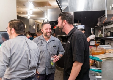 Mike Isabella (center) and partner George Pagonis (right) in the kitchen at Graffiato's five year anniversary celebration. (Photo: Rey Lopez)