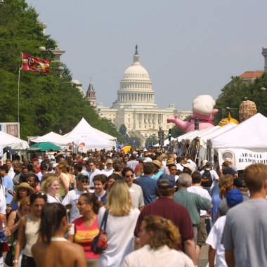 Crowds walking along Pennsylvania Avenue between vendors with the U.S. Capitol inthe background (Photo; National Capital Barbecue Battle)