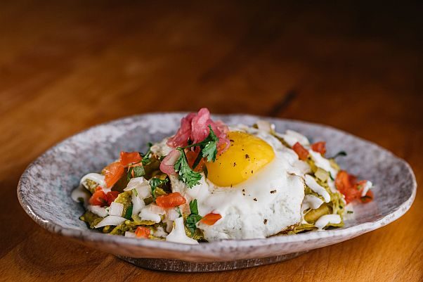 Buena Vida in Silver Spring is now serving unlimited weekend brunch including chilaquiles with corn tortilla chips, fried egg, salsa verde, cheese, crema fresca and pickled red onion for $35 per person. (Photo: Buena Vida)