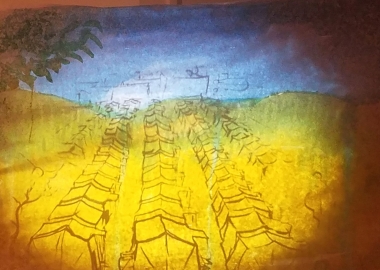 While Monica Dionysiou tells her story, artist Aaron Young illustrates it through live painting on a paper screen includng this painting of a tent city. (Photo: Mark Heckathorn/DC on Heels)