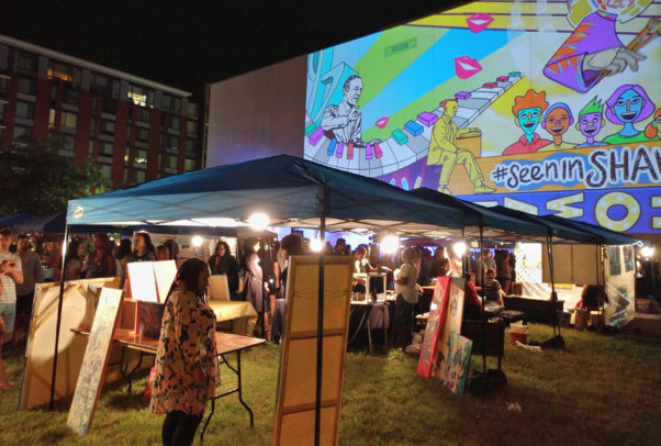 A giant animated Love Shaw projection looming over the art market. (Photo: Alexander M. Padro)