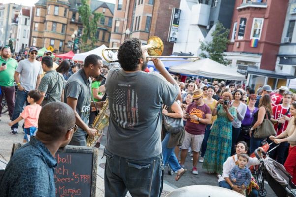 A crowd of people watching a band including a trumpet player at Adams Morgan Day. (Photo: Destination D.C.)