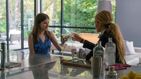 Anna Kendrick and Blake Lively sitting at a table toasting martinis. (Photo: Lionsgate Entertainment)