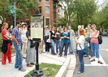 A group of people on a walking tour gathered around the guide. (Photo: Tourism D.C.)