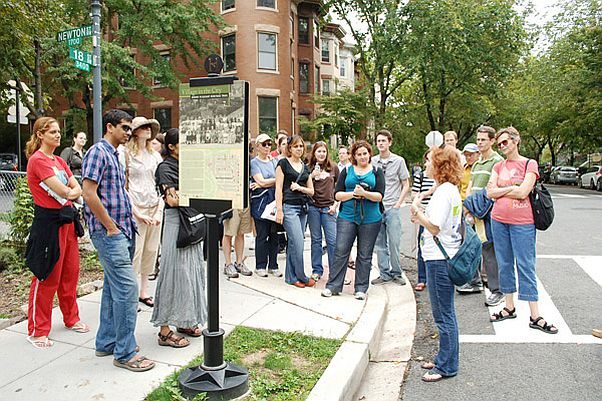 A group of people on a walking tour gathered around the guide. (Photo: Tourism D.C.)