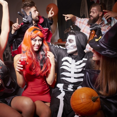 Three men and three women dressed in Halloween Costumes including witch, skelton and vampire at a house party. (Photo: Shutterstock)