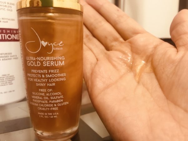 A bottle Ultra Nourishing Gold Serum beside a hand with some of the serum on it. (Photo: Emma Blancovich/DC on Heels)