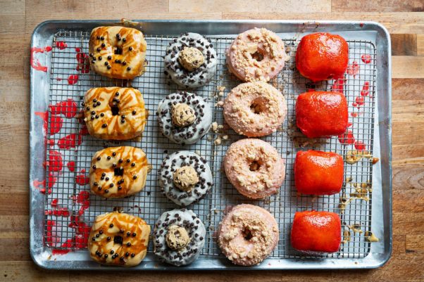 A baker's pan with four rows of four different kinds of doughnuts. (Photo: Scott Suchman)